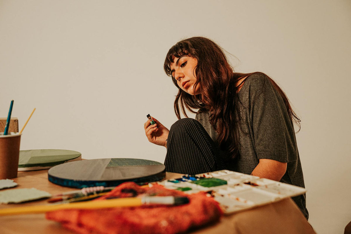 Emerging artist working on a vibrant painting in a bright Berlin studio