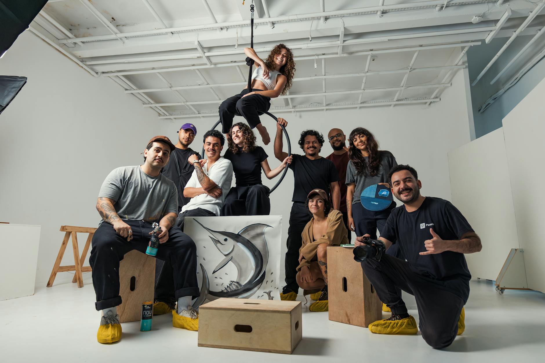 A group of diverse artists collaborating in a modern Berlin studio space