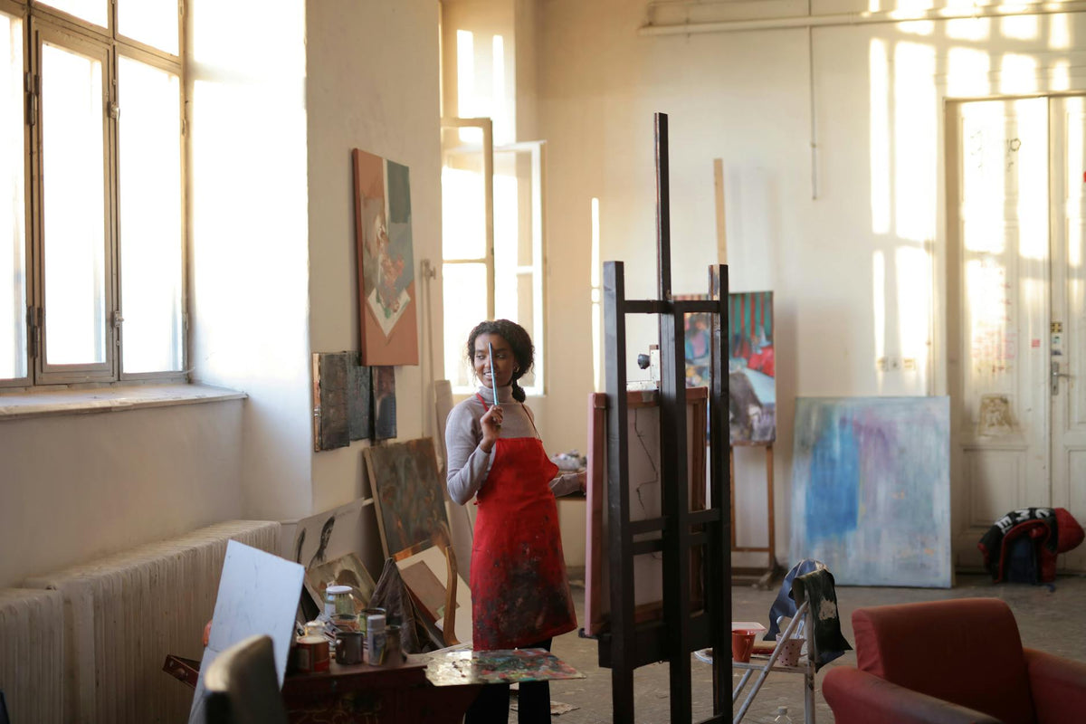 Emerging artist working in a Berlin studio surrounded by contemporary artworks